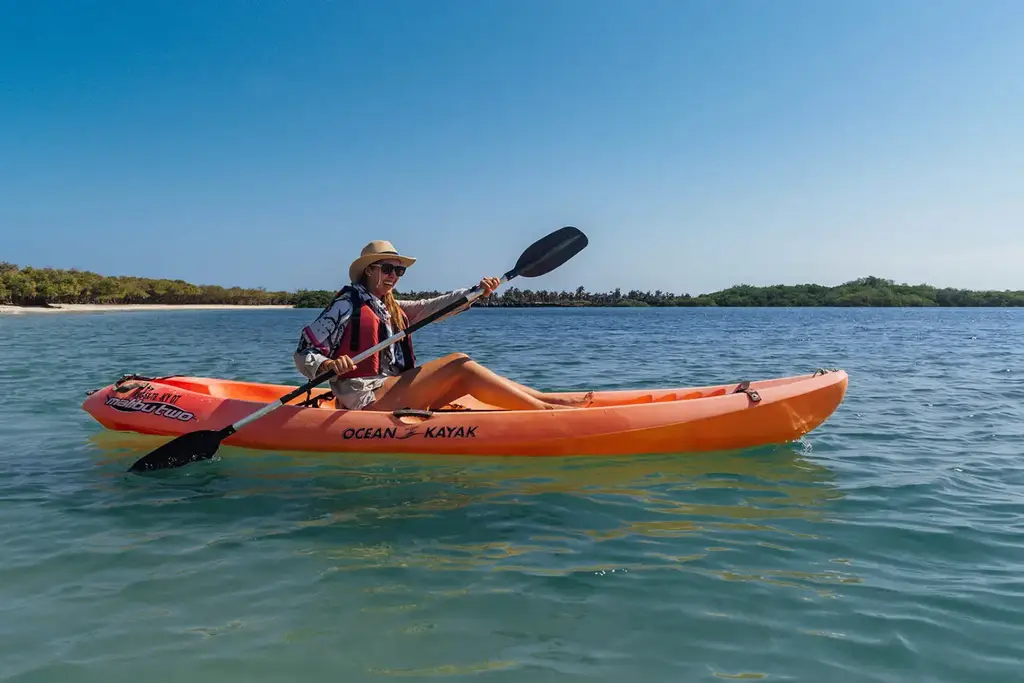 Kayaking in turquoise water at Tortuga Bay