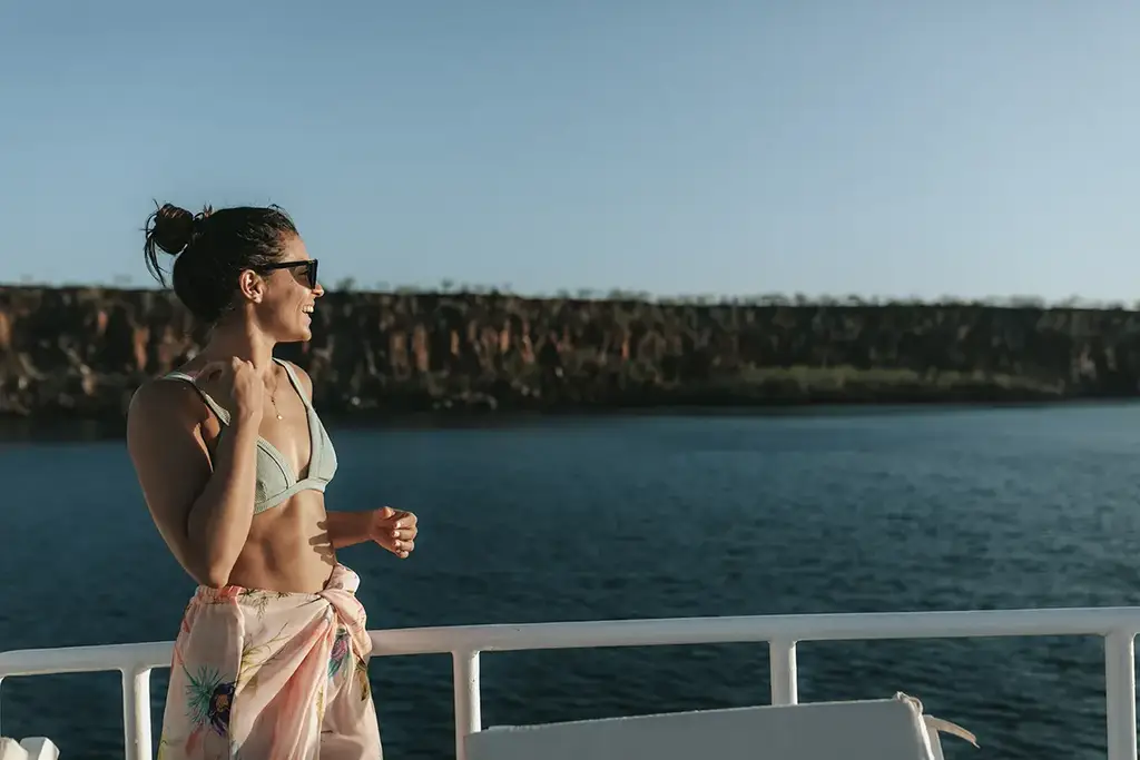 Guest looking out from the yacht deck