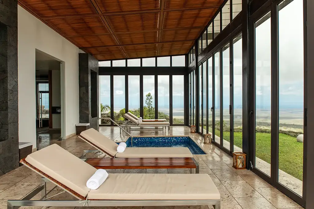 Spa lounge chairs and plunge pool with island views