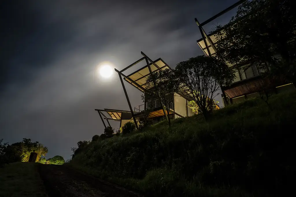 Pikaia Lodge at night, lights glowing across the highland building
